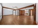 Spacious living room featuring hardwood floors, wooden beams and a cozy stone fireplace at 2649 Lake Harbin Rd, Morrow, GA 30260