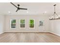 Bright, open living room with hardwood floors, recessed lighting, and multiple windows with a backyard view at 105 Priestwood Ln, Acworth, GA 30102