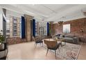 Bright living room featuring exposed brick walls, large windows with cityscape views, and modern decor at 434 Marietta Nw St # 301, Atlanta, GA 30313