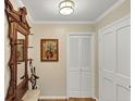 Inviting hallway with hardwood floors, coat rack, and neutral paint, leading to other rooms at 30 Chaumont Nw Sq, Atlanta, GA 30327