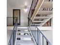 Stairwell leading up to unit showcasing neutral carpet, black metal handrails, and natural light at 30 Chaumont Nw Sq, Atlanta, GA 30327
