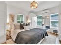Bright main bedroom features stylish decor, closet, and lots of natural light from the two large windows at 575 E Main St, Buford, GA 30518