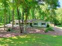 Inviting single-story home with lush lawn and mature trees, providing a serene setting at 1379 Branchwood Dr, Snellville, GA 30078