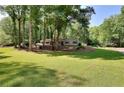 Spacious front yard and mature trees enhance the curb appeal of this single-story home at 1379 Branchwood Dr, Snellville, GA 30078