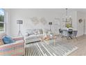 Sun-filled living room featuring modern decor, stylish furnishings, and contemporary lighting at 170 Chandler Trce, Covington, GA 30016