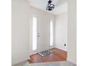 Inviting foyer with hardwood floors, large front door, and natural light at 4527 Baker Grove Nw Rd, Acworth, GA 30101