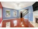 Bright living room features gleaming floors, a fireplace, and plenty of natural light at 5292 Windfield Glen Nw Ct, Lilburn, GA 30047