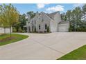 Expansive driveway leading up to a gorgeous stone home with a two-car garage at 126 Owens Mill Pl, Canton, GA 30115