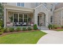 Inviting front porch featuring stone accents, cozy seating, and lush landscaping at 126 Owens Mill Pl, Canton, GA 30115