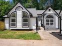 Charming home featuring black trim, arched windows, and a freshly landscaped yard with lush grass at 3100 Mount Gilead Sw Rd, Atlanta, GA 30311