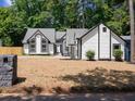 Charming home featuring black trim, arched windows, and a freshly landscaped yard at 3100 Mount Gilead Sw Rd, Atlanta, GA 30311