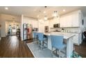 Modern kitchen with granite countertops, stainless steel appliances, and stylish seating at the island at 3430 Summerpoint Xing, Cumming, GA 30028