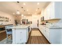 Bright kitchen featuring white cabinetry, granite countertops, an island and stainless steel appliances at 3430 Summerpoint Xing, Cumming, GA 30028