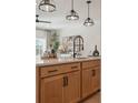 Close-up of kitchen island featuring quartz countertop, modern faucet, and stylish lighting at 428 Carrera Ln, Acworth, GA 30102