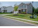 Attractive two-story home on a lush green lawn with landscaped curb appeal and a long driveway at 6827 Chataran Dr, Lithia Springs, GA 30122
