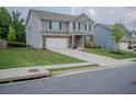 Charming two-story home with a spacious lawn and long drive way at 6827 Chataran Dr, Lithia Springs, GA 30122