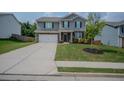 Charming two-story home featuring a two-car garage, landscaped yard and manicured lawn at 6827 Chataran Dr, Lithia Springs, GA 30122
