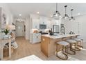 Open-concept kitchen with a quartz countertop island and stainless steel appliances and view to the entryway at 436 Carrera Ln, Acworth, GA 30102