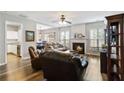 Open-concept living room featuring hardwood floors and access to kitchen and dining at 113 Regent Pl, Woodstock, GA 30188