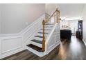 Elegant staircase with decorative molding and hardwood floors at 113 Regent Pl, Woodstock, GA 30188