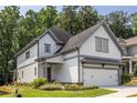 Beautiful two-story home showcases white siding, gray trim, a two-car garage, and an inviting landscaped front yard at 1753 Russell Se St, Atlanta, GA 30316