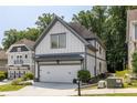 Attractive two-story home displays white siding, gray trim, a two-car garage, and well-maintained landscaping at 1753 Russell Se St, Atlanta, GA 30316