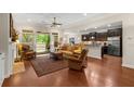 Open concept living room featuring hardwood floors, neutral paint, ceiling fan, and easy access to an outdoor patio at 325 Ridge Hill Cir # 3, Marietta, GA 30064