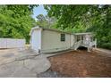 Exterior view of the house with concrete patio and white fence at 6201 Davids Se Way, Acworth, GA 30102