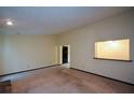 Spacious living room with neutral walls, carpeting and a convenient pass-through to another room at 1070 Salisbury Trl, Riverdale, GA 30296