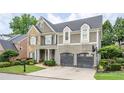Charming two-story home featuring a stone facade, shingle siding, a two-car garage and manicured landscaping at 1075 Bluffhaven Way Northeast Ne Way, Atlanta, GA 30319