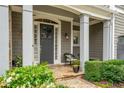 Inviting front entrance features a covered porch with stone accents, columns, and decorative plantings at 1075 Bluffhaven Way Northeast Ne Way, Atlanta, GA 30319