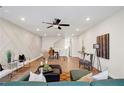 Open living room features recessed lighting, hardwood floors, and geometric accent wall at 2030 Main Nw St # 205, Atlanta, GA 30318
