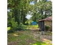 View of backyard featuring a detached structure, showcasing the lot's potential at 3547 Pleas Dr, Ellenwood, GA 30294