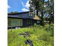 Rear exterior view highlighting the architectural style and backyard space at 3547 Pleas Dr, Ellenwood, GA 30294