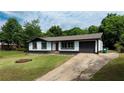 Charming single-story home featuring a well-maintained yard and a long driveway at 5 Citation Ct, Ellenwood, GA 30294