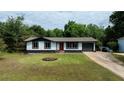 Well-maintained single-story home with a lush green lawn and mature trees in the background at 5 Citation Ct, Ellenwood, GA 30294