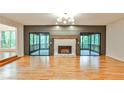 Spacious living room with stone fireplace and sliding doors to screened deck at 2189 Cedar Forks Dr, Marietta, GA 30062