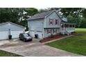 This residence includes a detached garage and a driveway with ample parking space, enhancing convenience for multiple vehicles at 24 Lady Savannah Dr, Dallas, GA 30157