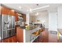 Modern kitchen with stainless steel appliances, a center island, and hardwood floors at 4561 Olde Perimeter Way # 806, Dunwoody, GA 30346