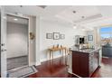 The kitchen features an eat-in island, stainless appliances, and views to the outside balcony at 4561 Olde Perimeter Way # 806, Dunwoody, GA 30346