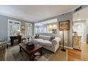 Open-concept living room with hardwood floors, a comfortable sofa, and a view into the adjacent kitchen at 50 Biscayne Nw Dr # 4110, Atlanta, GA 30309
