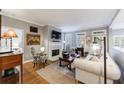 Bright living room with a fireplace, large window, hardwood floors, and a neutral color palette at 50 Biscayne Nw Dr # 4110, Atlanta, GA 30309