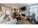 Comfortable living room featuring a decorative fireplace, hardwood floors, and plenty of natural light at 50 Biscayne Nw Dr # 4110, Atlanta, GA 30309