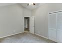 Neutral bedroom features vaulted ceiling, closet and doorway to other rooms at 5930 Bridle Dr, Cumming, GA 30028