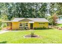 Charming brick home with well-manicured lawn, mature trees, and inviting carport at 3467 Pinehill Dr, Decatur, GA 30032