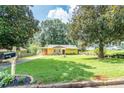 Well-maintained home with a lush front yard, mature trees, and a convenient carport at 3467 Pinehill Dr, Decatur, GA 30032