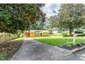 Inviting home with expansive lawn, mature trees, and a welcoming, covered carport at 3467 Pinehill Dr, Decatur, GA 30032