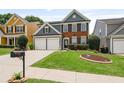 Attractive two-story home with a manicured lawn, mature landscaping, and a spacious driveway leading to a two-car garage at 4312 Shillham Ct, Cumming, GA 30040