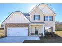 Two-story house with stone accents, a two-car garage, and a covered front entry at 484 Charleston Pl, Villa Rica, GA 30180