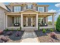 Inviting front porch with comfortable seating, lovely landscaping, and a clear walkway to the front door at 5070 Laurel Ridge Dr, Cumming, GA 30040